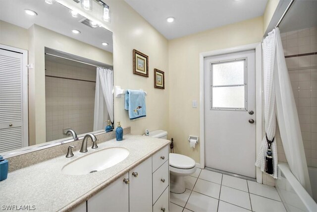 full bathroom featuring vanity, tile patterned floors, shower / tub combo, and toilet