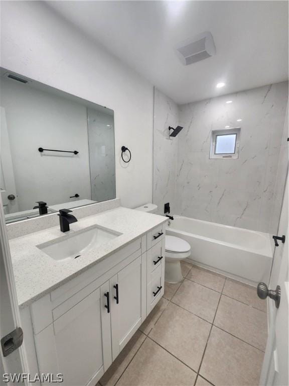 full bathroom with tiled shower / bath combo, vanity, tile patterned floors, and toilet