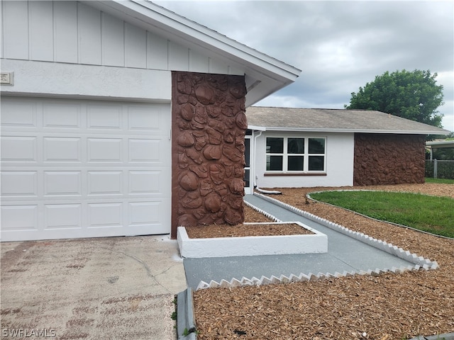 doorway to property featuring a garage