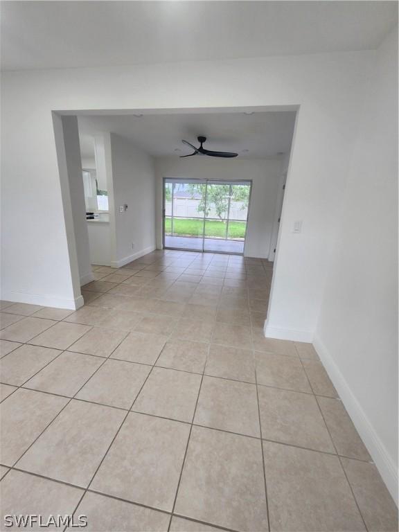 empty room with light tile patterned flooring and ceiling fan