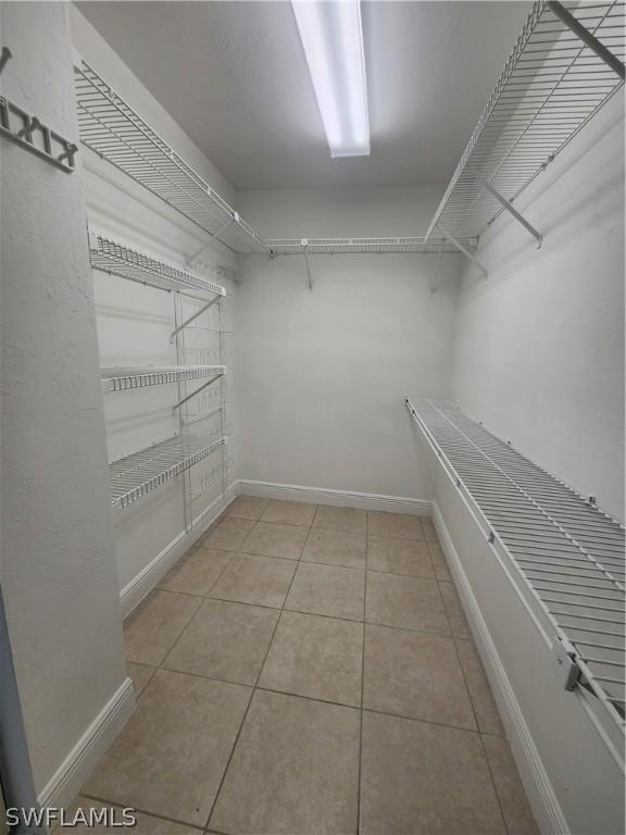 spacious closet featuring light tile patterned flooring