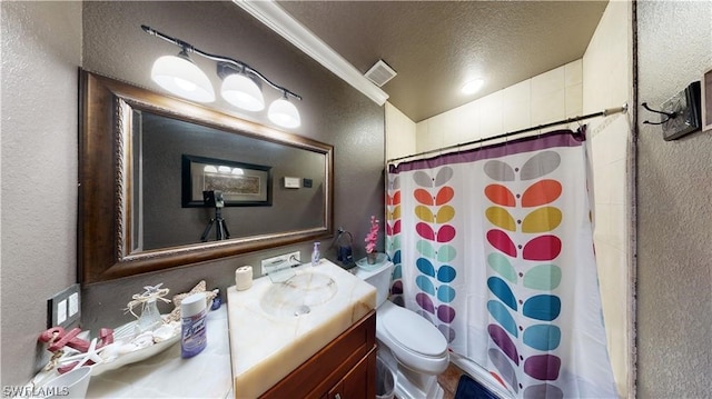 bathroom featuring vanity, a textured ceiling, and toilet