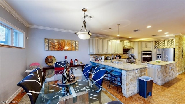 tiled dining room with sink and crown molding