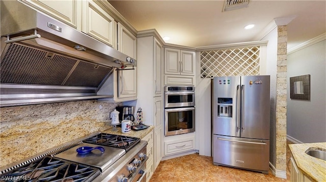 kitchen featuring light tile patterned flooring, backsplash, cream cabinetry, light stone counters, and stainless steel appliances