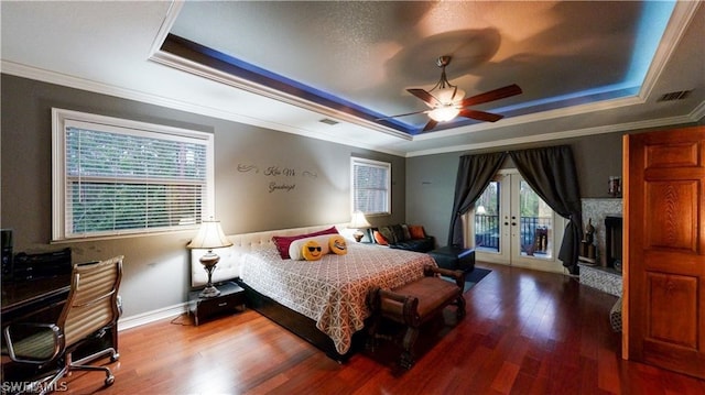 bedroom featuring wood-type flooring and a tray ceiling