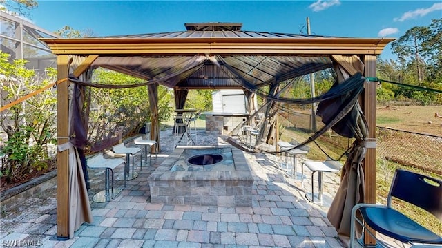 view of patio featuring a gazebo and a fire pit