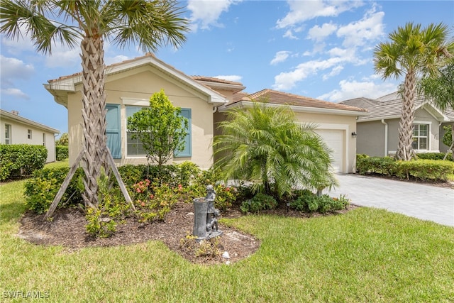 view of front of property with a front lawn and a garage