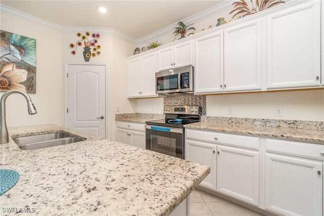 kitchen featuring crown molding, stainless steel appliances, white cabinetry, light tile patterned floors, and sink