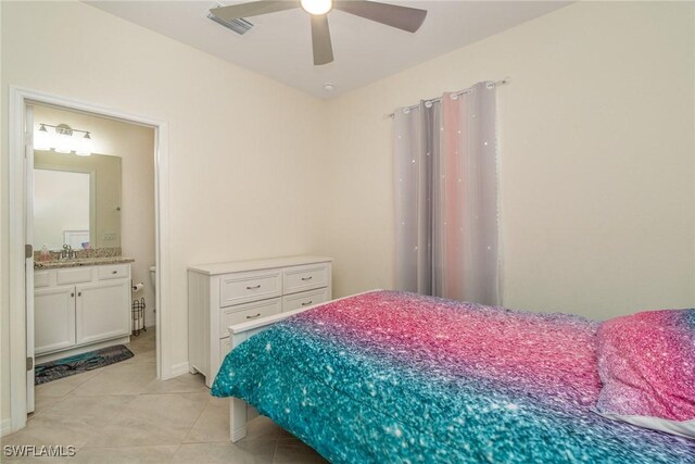 tiled bedroom featuring ceiling fan and ensuite bathroom