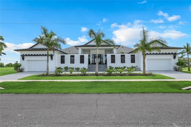 ranch-style house with a garage and a front lawn