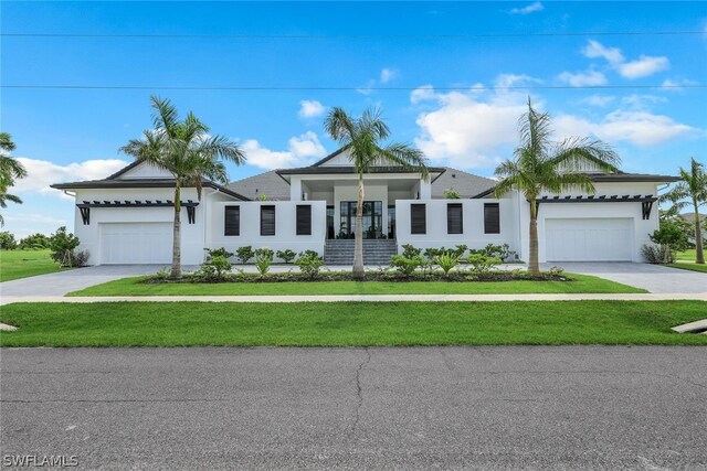 single story home with a garage and a front yard