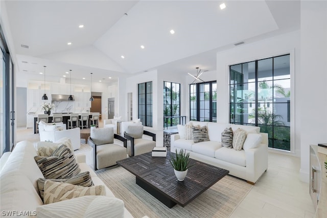 living room featuring light tile patterned floors and high vaulted ceiling