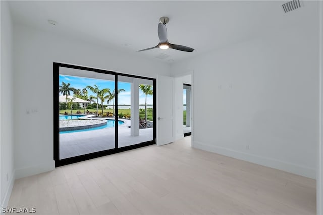 empty room with light hardwood / wood-style floors and ceiling fan