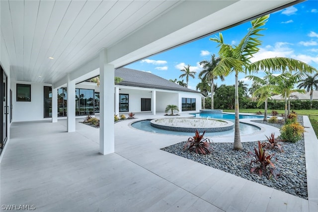 view of swimming pool featuring a patio and an in ground hot tub