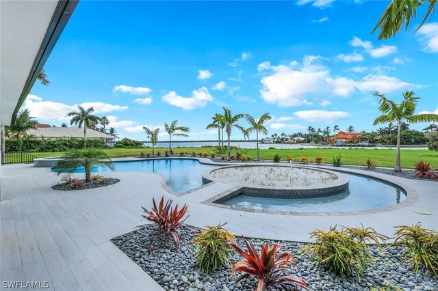 view of swimming pool featuring a patio and a yard