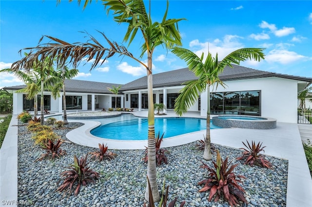 view of swimming pool featuring an in ground hot tub and a patio