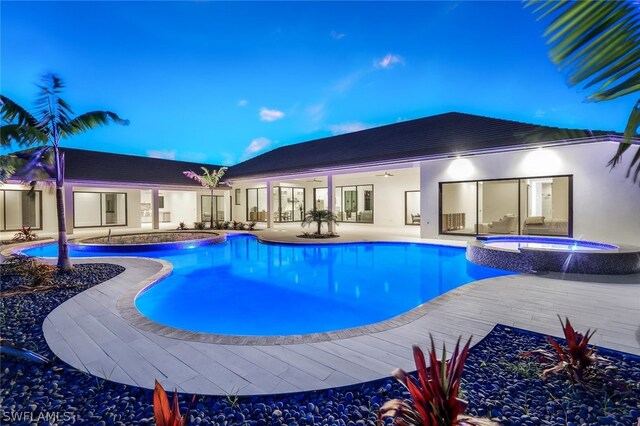 view of swimming pool featuring an in ground hot tub and a patio area