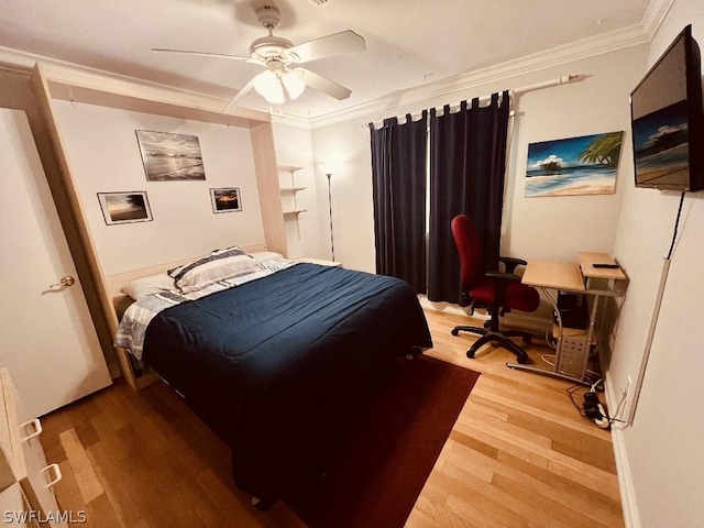 bedroom with ceiling fan, wood finished floors, and crown molding