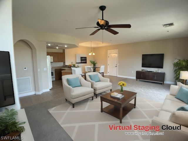 tiled living room with ceiling fan