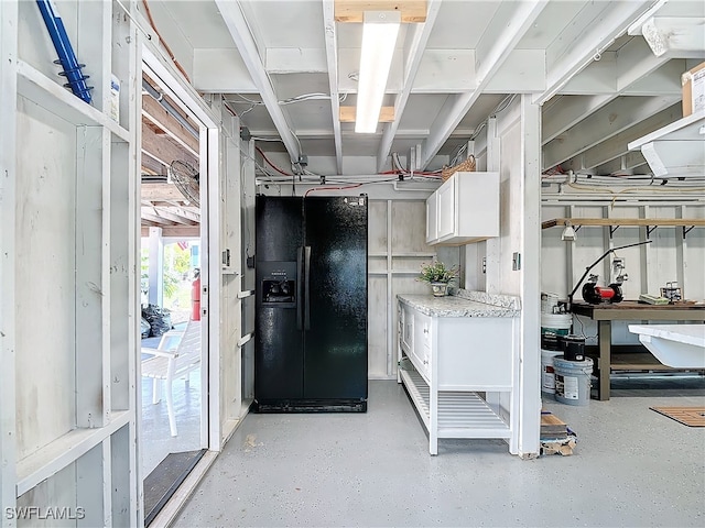 interior space featuring black refrigerator with ice dispenser