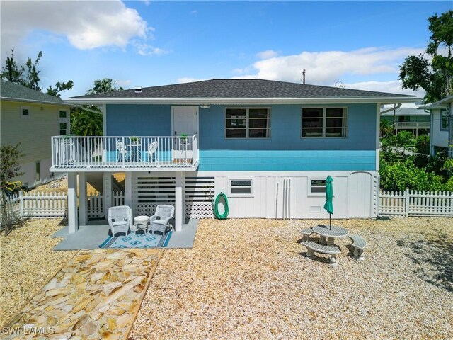 back of property featuring a patio area and a deck