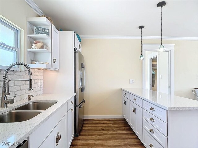 kitchen with sink, light stone counters, white cabinetry, and dark hardwood / wood-style floors