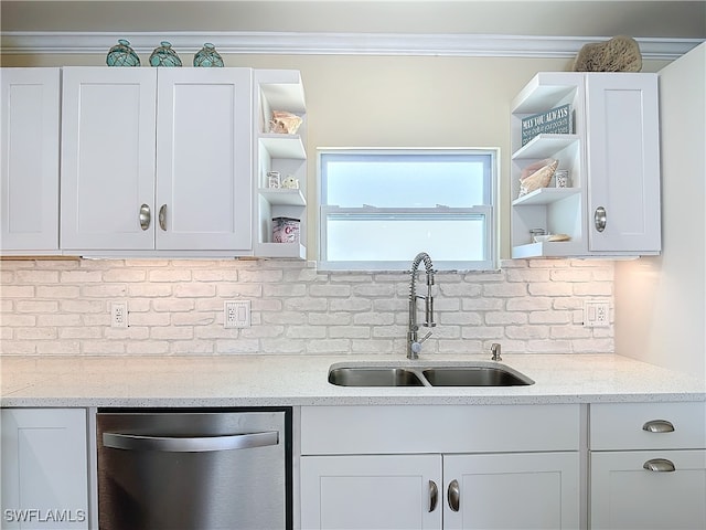 kitchen with decorative backsplash, stainless steel dishwasher, white cabinetry, light stone countertops, and sink