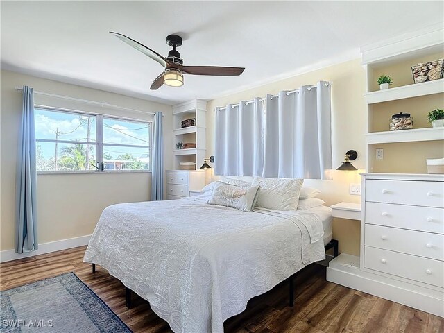 bedroom with ceiling fan and hardwood / wood-style flooring