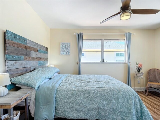 bedroom with ceiling fan and hardwood / wood-style flooring