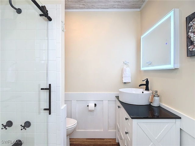 bathroom with hardwood / wood-style floors, toilet, and vanity