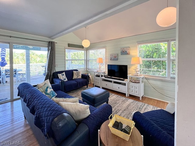 living room featuring vaulted ceiling with beams and hardwood / wood-style floors