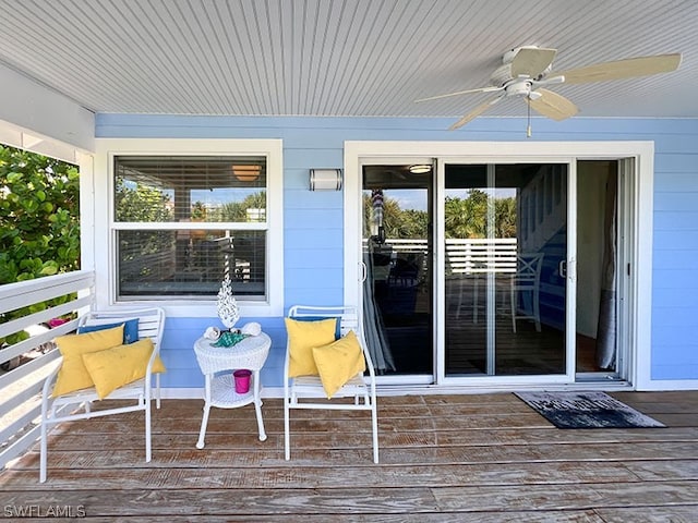 wooden deck featuring ceiling fan