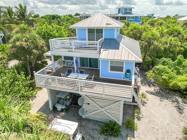 back of house featuring a deck