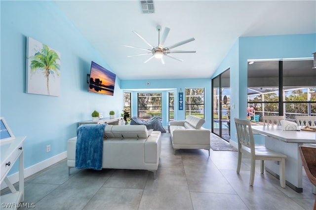 living room with ceiling fan, vaulted ceiling, and plenty of natural light