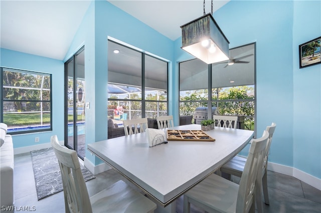 dining area with ceiling fan, lofted ceiling, and plenty of natural light