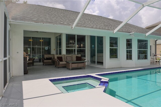 view of swimming pool featuring a patio area, glass enclosure, an in ground hot tub, and outdoor lounge area