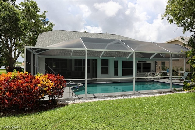 view of swimming pool with a patio, a lanai, and a yard