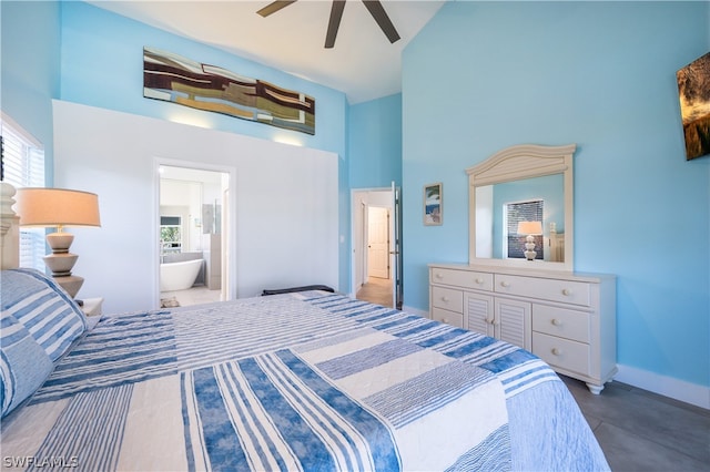 bedroom with high vaulted ceiling, ensuite bath, and ceiling fan