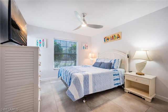 bedroom featuring dark tile patterned floors and ceiling fan