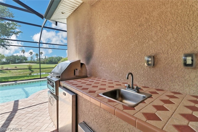 view of patio featuring area for grilling and sink