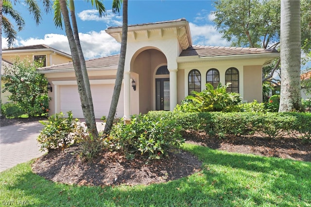 mediterranean / spanish-style home with a garage