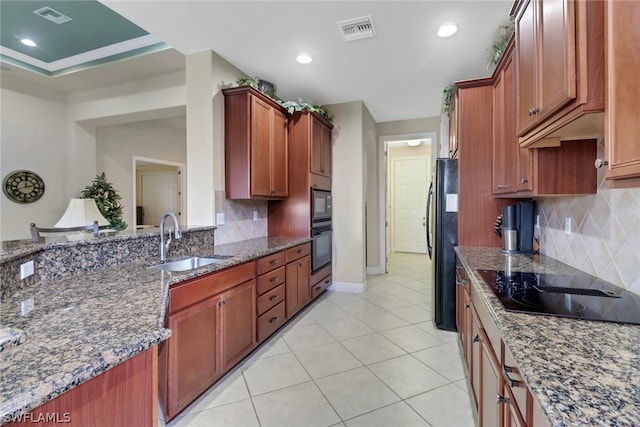 kitchen featuring sink, tasteful backsplash, black appliances, light tile patterned flooring, and dark stone counters