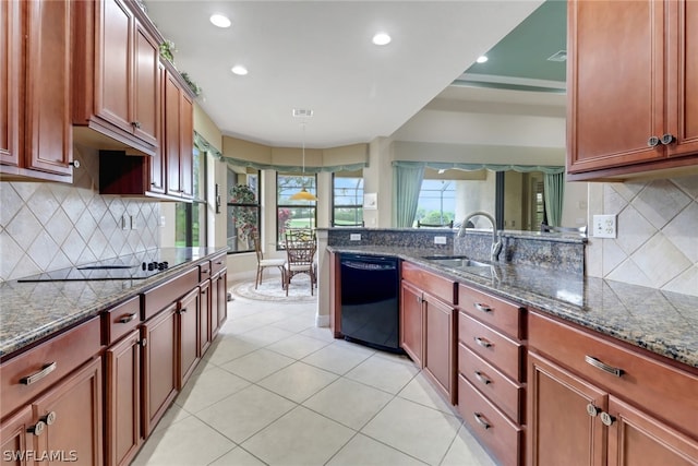 kitchen featuring sink, dark stone counters, and black appliances