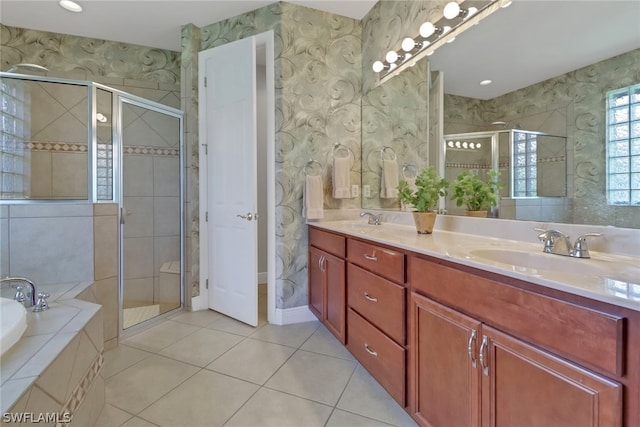 bathroom with vanity, independent shower and bath, and tile patterned flooring