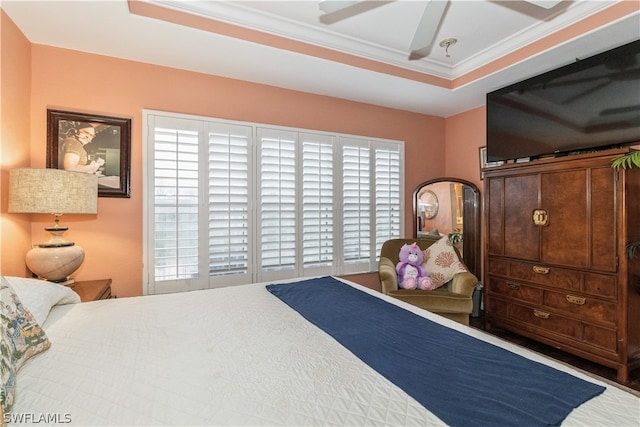 bedroom with a tray ceiling, ceiling fan, and ornamental molding