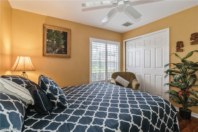 bedroom with hardwood / wood-style floors, a closet, and ceiling fan