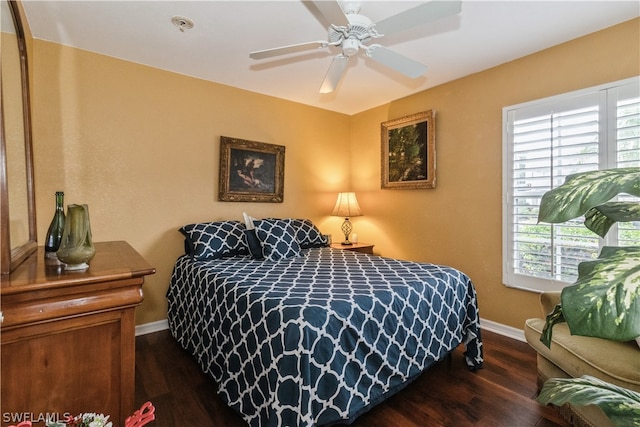 bedroom featuring multiple windows, ceiling fan, and dark wood-type flooring