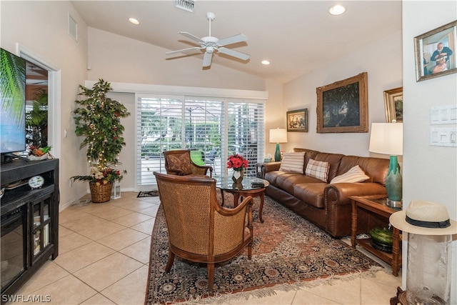 living room with light tile patterned flooring, ceiling fan, and vaulted ceiling