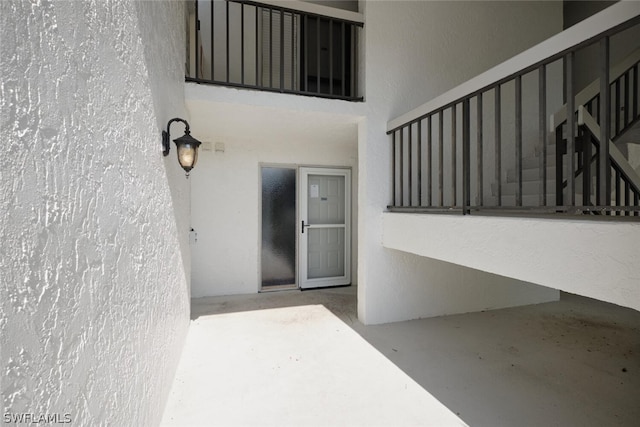 16580 Waters Edge Ct Unit 102, Fort Myers, FL 33908 - property entrance with stucco siding and a patio