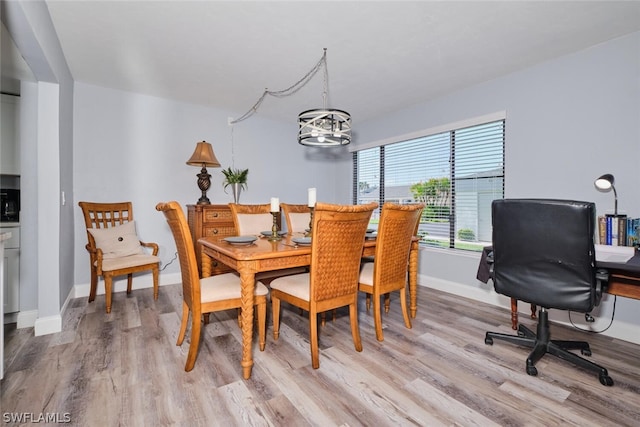 16580 Waters Edge Ct Unit 102, Fort Myers, FL 33908 - dining area featuring baseboards, wood finished floors, and an inviting chandelier